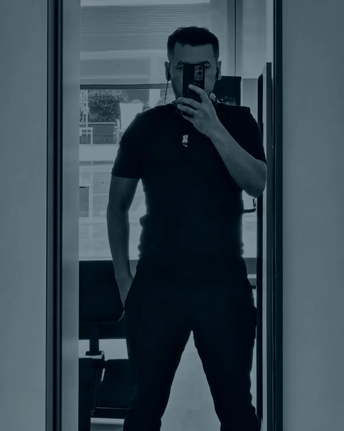 Black-and-white self portrait of Jun in a mirror