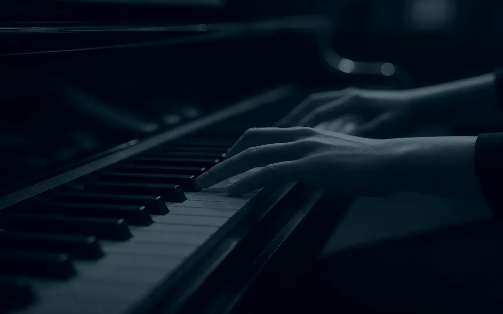 Piano keys in a dark practice setting